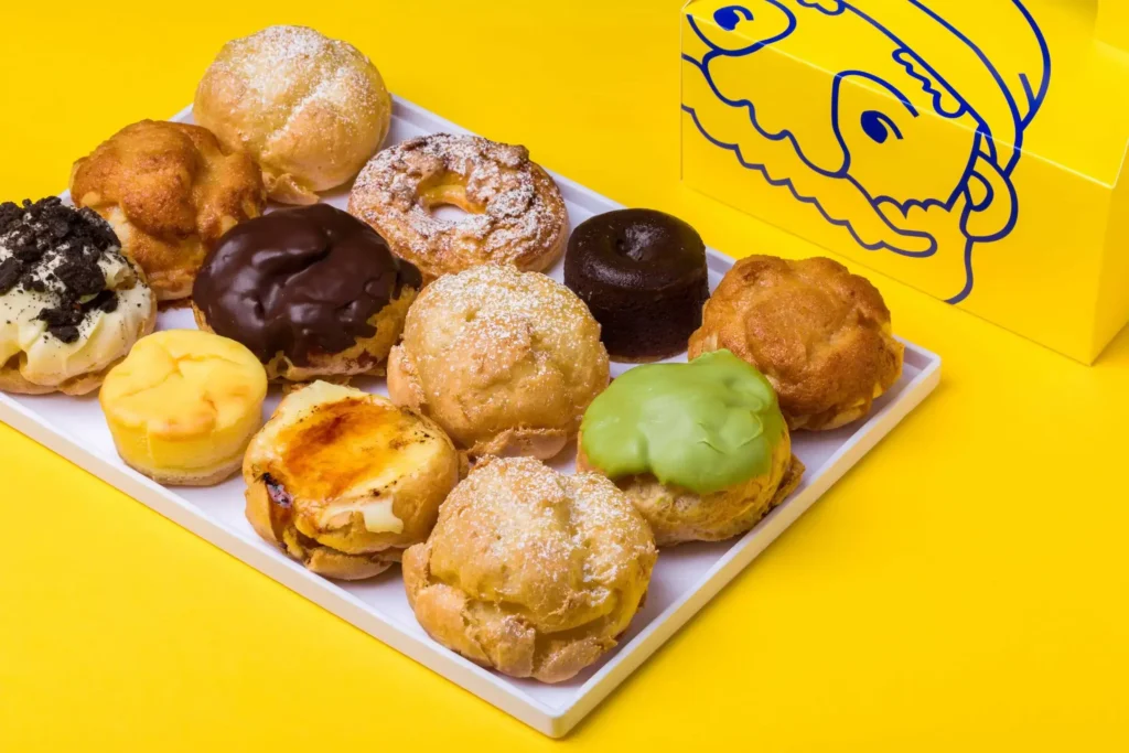 An enticing image showcasing Beard Papa's Custard Prices, featuring a delightful selection of custard puffs in various flavors, promising a sweet and creamy treat for dessert enthusiasts.